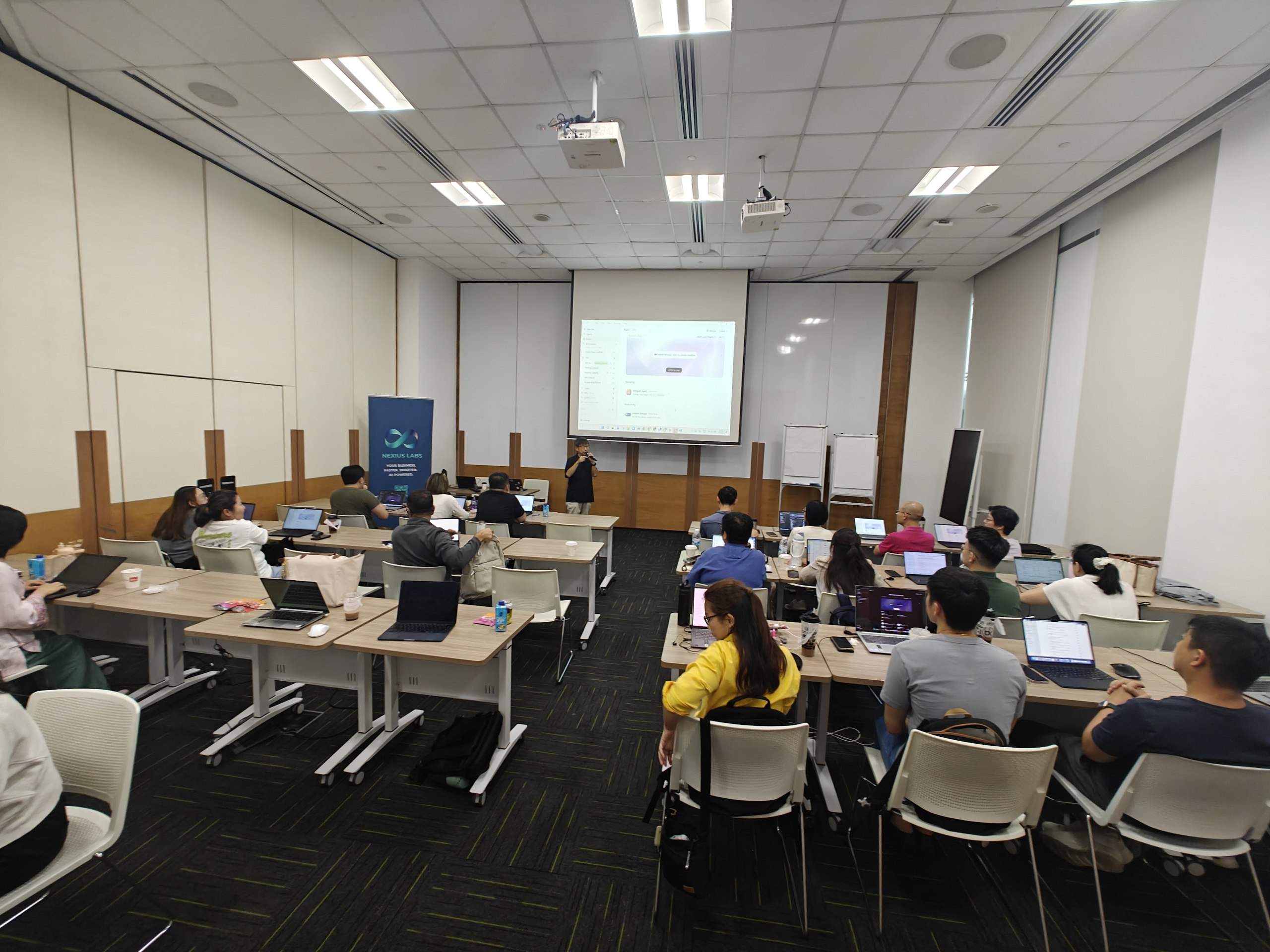 Foundation participants practising with laptops while a trainer guides the classroom