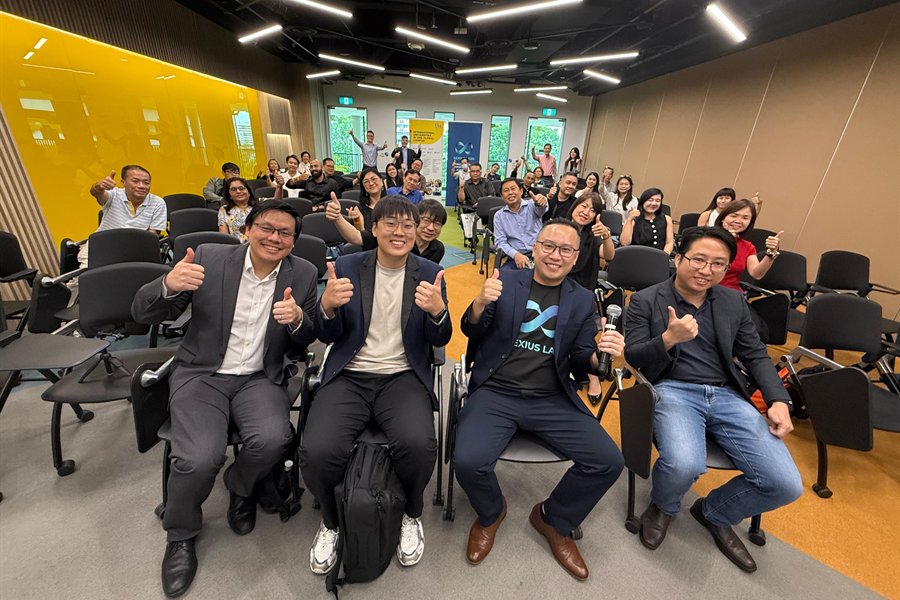 Participants and trainers giving thumbs up at an AI business workshop